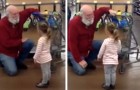 This little girl sees a man with a white beard at the supermarket and mistakes him for Santa Claus