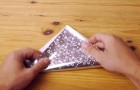 He starts by folding some wrapping paper, but what this man creates will surprise you!