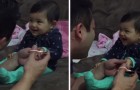 Watch the reaction of this baby, when daddy tries to cut her nails ...