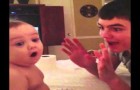 The older brother performs a magic trick; the baby brother's reaction is priceless!