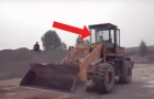 A wheeled loading shovel truck is moving --- but who is driving it?