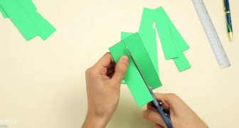 He starts by cutting a sheet of paper into strips. His final creation? GENIUS!