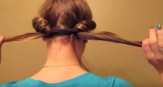 She rolls up her hair in a band, when she takes it off effect is surprising