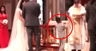 What this child does when taking the rings up the altar, makes even the priest laugh !!