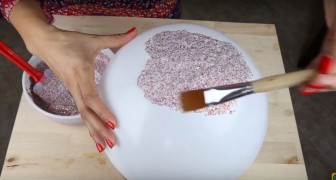 She mixes glitter and glue in a bowl and creates a really awesome object !