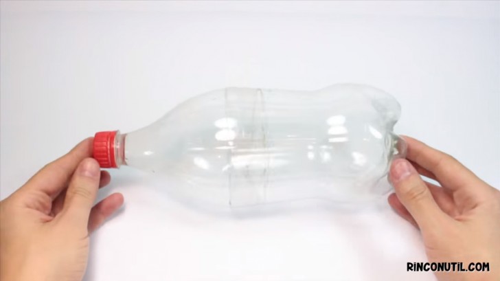 1. Klipp flaskan i mitten med hjälp av saxen så ni får en mindre flaska.