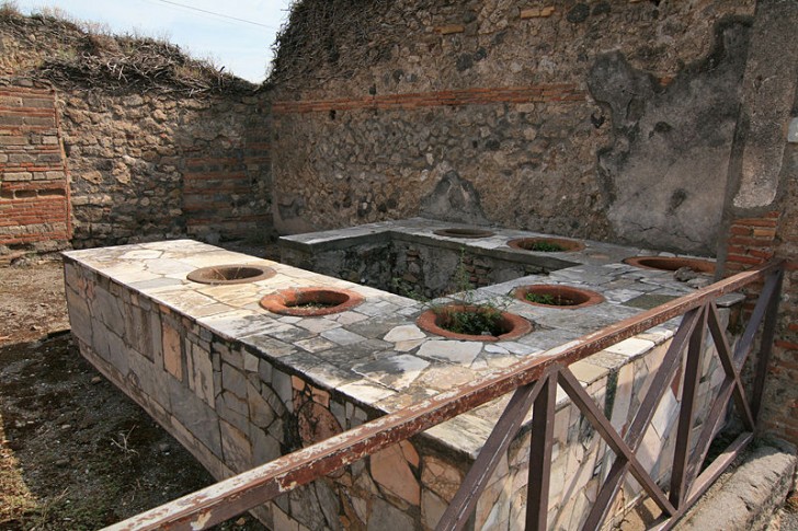 I thermopolia erano strutture costituite da un bancone in muratura nel quale erano inserite diverse 'dolia', contenitori di terracotta usati per conservare gli alimenti usati nella preparazione dei pasti caldi.