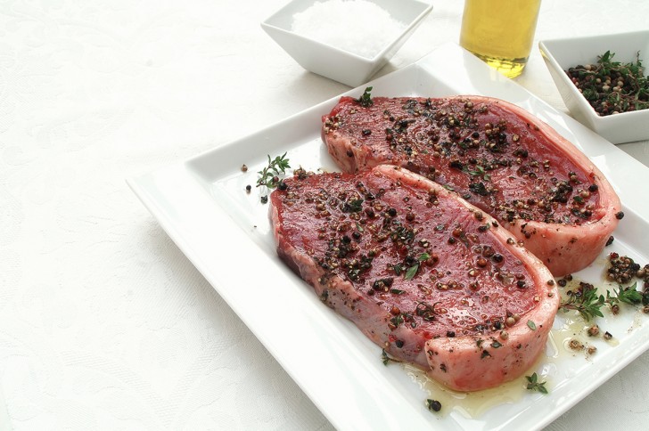 Just brush both sides of the steak with a few drops of olive oil and some aromatic spices, such as rosemary and thyme.