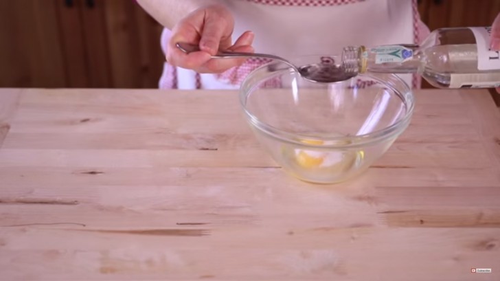 In a mixing bowl combine the ingredients in the following order: one egg, sugar, liquor, olive oil, lemon zest and a pinch of salt.