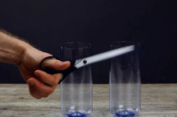 Rinse the plastic bottles and cut them in half.