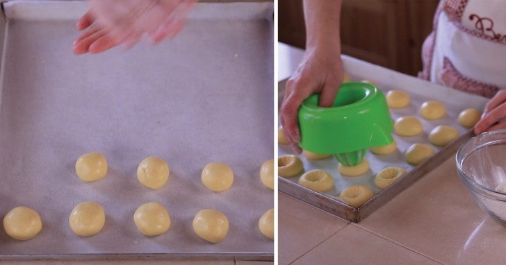 3. From the dough, make balls of equal size and place them in a baking tray lined with parchment paper. Make the cavity where you are going to put the orange flavored cream by using a juicer (sprinkle flour on the tip so that it will not stick to the dough).