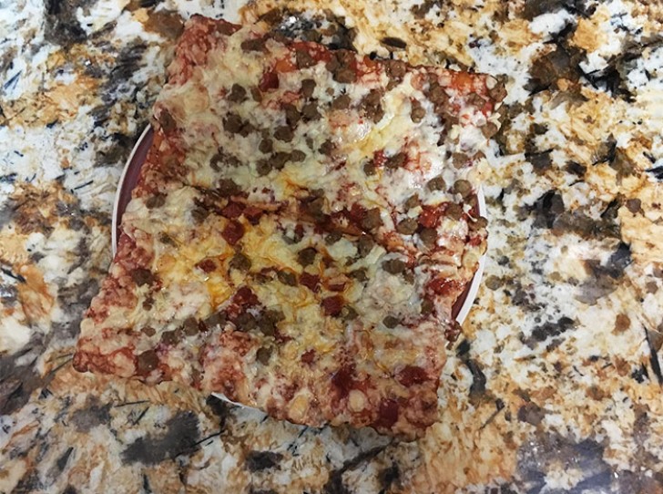 9. A plate of pizza on a marble table ...
