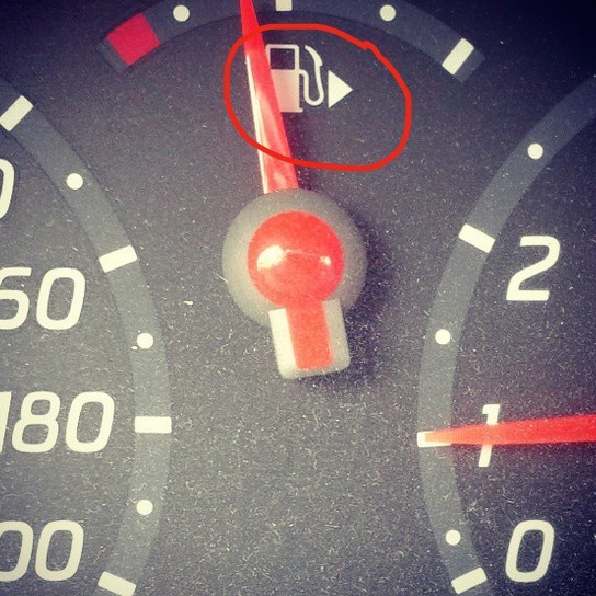 The little arrow on a car's fuel gauge