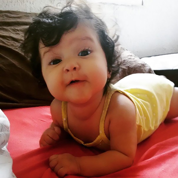 This baby definitely wins the title of Miss "Curly Hair"!