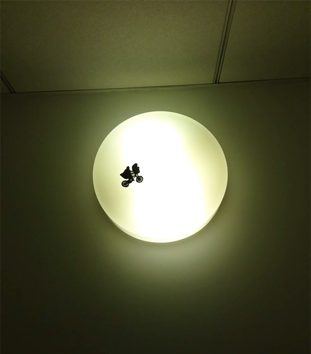 2. A simple and suggestive sticker attached to a ceiling lamp in a public bathroom.