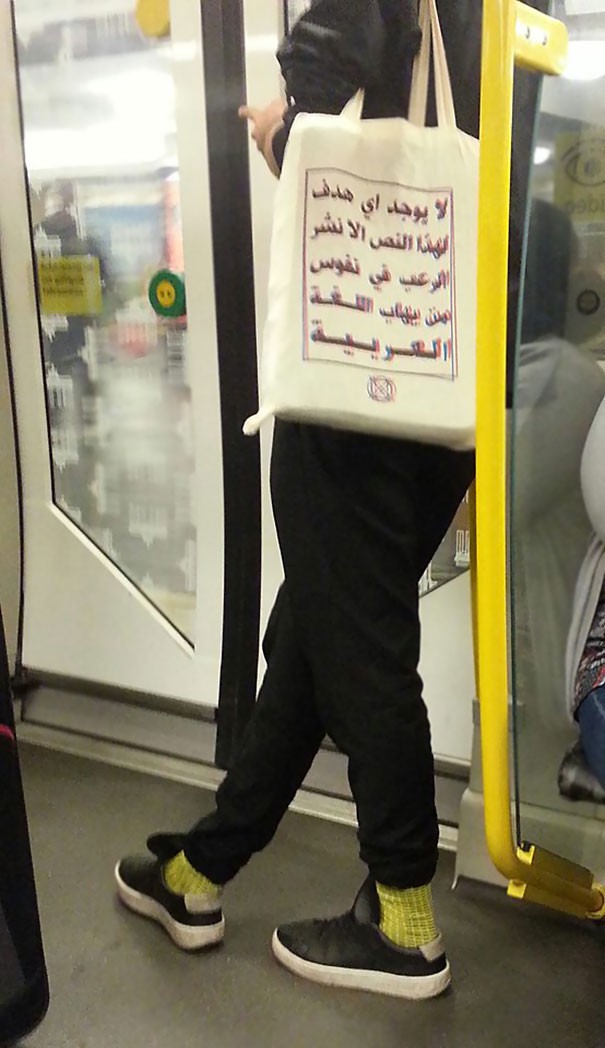 The text on the tote bag reads: "This text has no other purpose than to spread terror in the hearts of those who are afraid of the Arabic language."