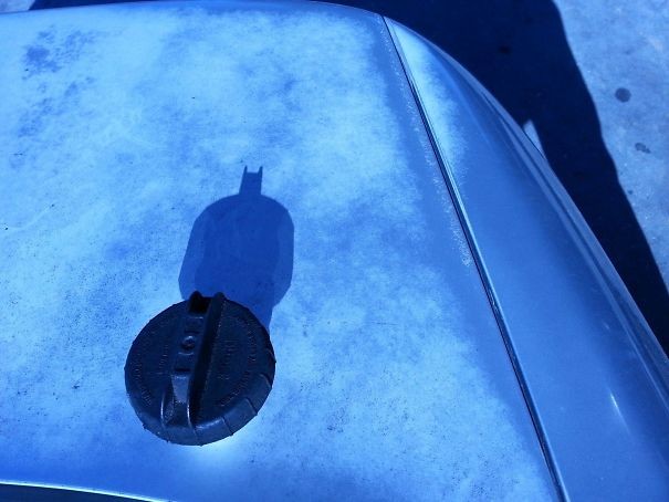 12. The gas tank cap has created a shadow figure that looks exactly like the famous Batman Shadow!