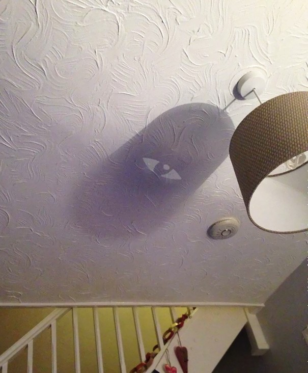18. A ceiling light fixture shadow that changes into an all-seeing eye.