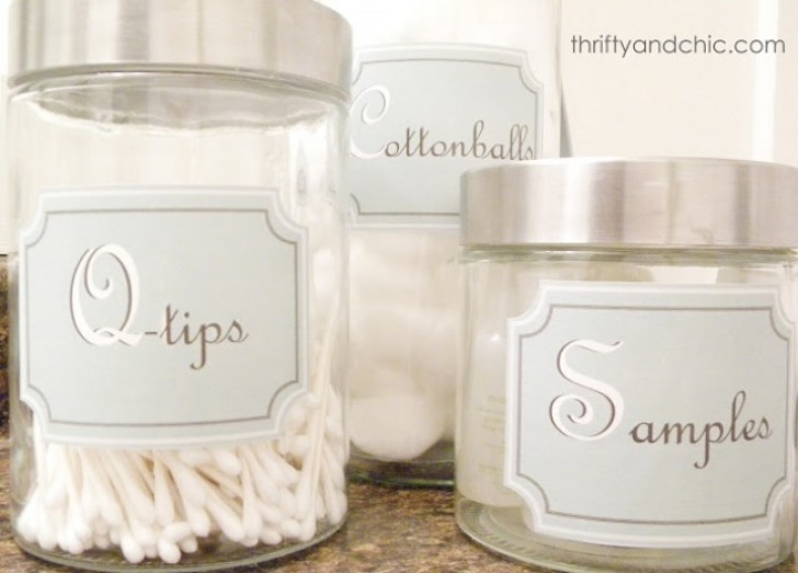 16. Decorate with elegant labels glass jars that contain cotton, makeup remover cotton disks, and various bathroom product samples.