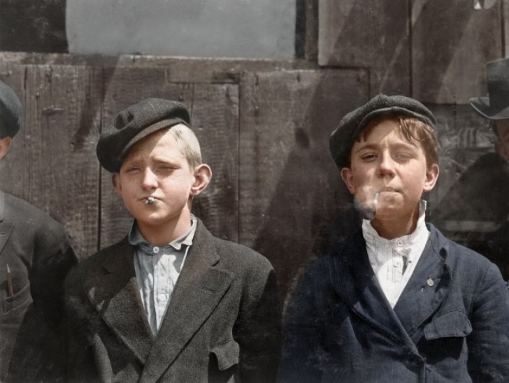 17. Very young paperboys during a break from selling newspapers on the city streets.