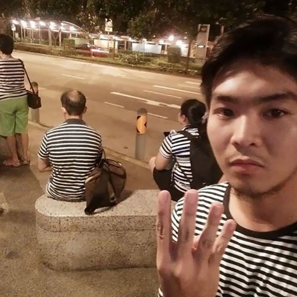 12. Four people at the same bus stop. All wearing a white and black striped t-shirt!