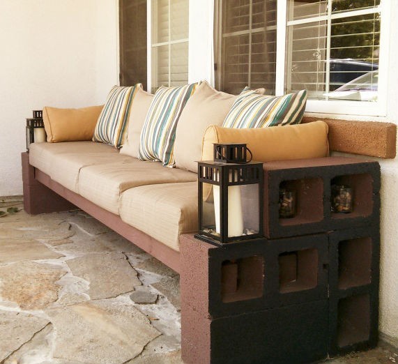 Another comfortable sofa with wooden boards and colored or painted cement blocks.