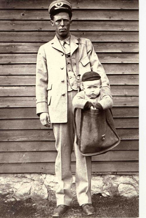 4. A postman carrying a baby boy, probably, his son.