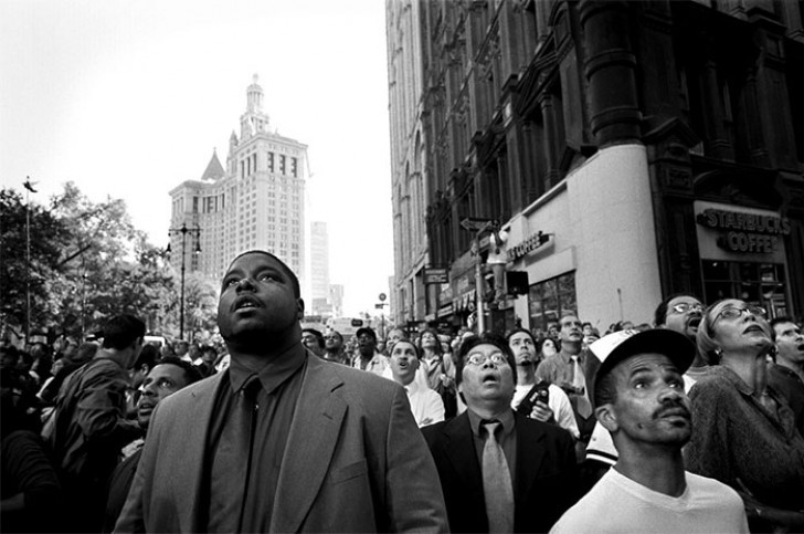 1. A crowd of people looks at the towers from Park Row and Beekman Street.