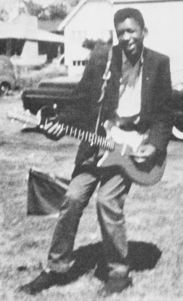 16. Jimi Hendrix with the first guitar he bought to start practicing.