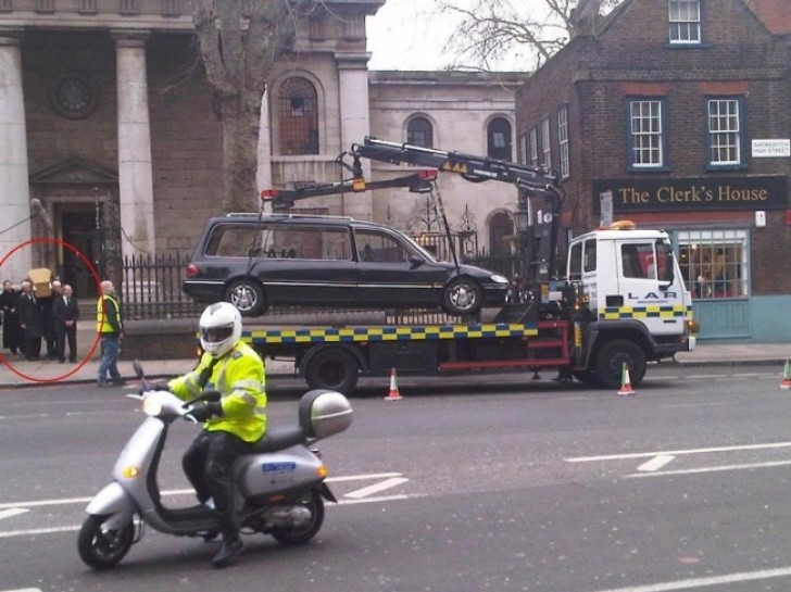 Coincidence dictates that at that very moment the funeral car is being towed away!