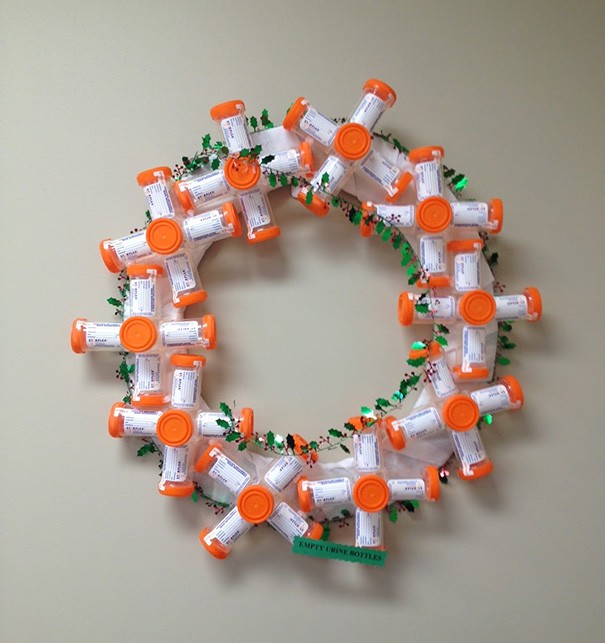 A Christmas wreath created with plastic urine sample containers.