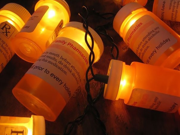 Empty medicine bottles filled with Christmas lights.