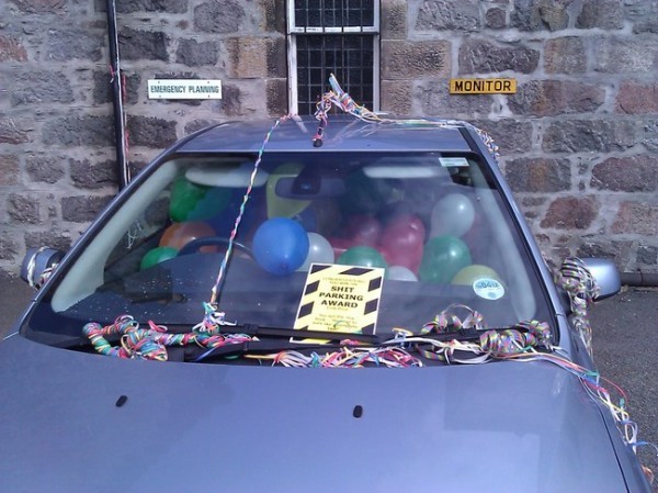 11. This person parked badly and so someone gave him/her a prize with a lot of party favors!
