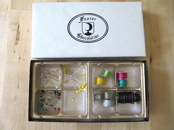 An old box of chocolates can help you keep your sewing notions and tools in order.