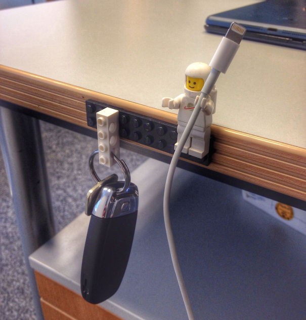 A little Lego man that keeps the cable in order and two lego bricks that keep your keys where you can easily find them.