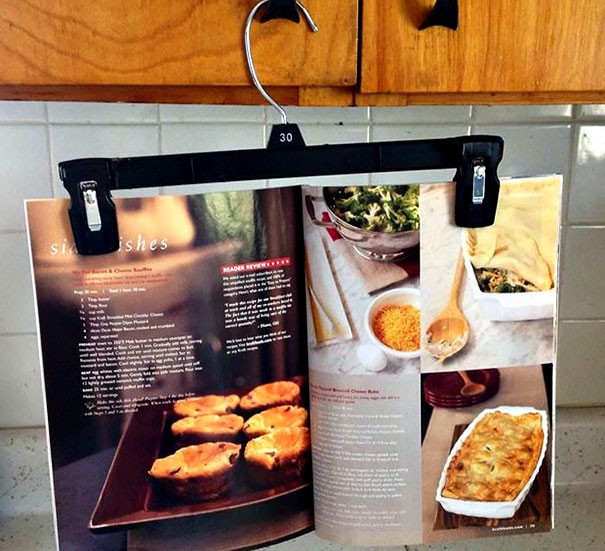 A clothes hanger in the kitchen can be used to keep recipe books open.