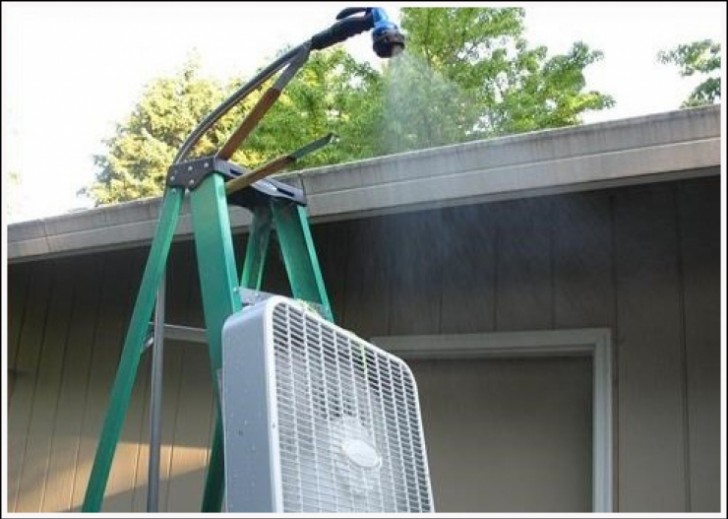 2 - Someone has set up a ladder, a hose with a showerhead, and a fan to make a "misting" watering system for their garden!