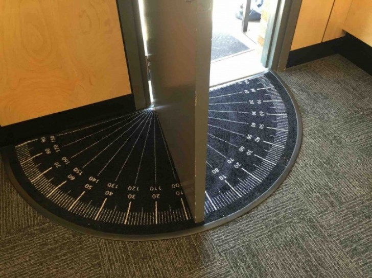 A rubber doormat in the shape of a protractor which is useful to put in schools to help students learn to measure angles!