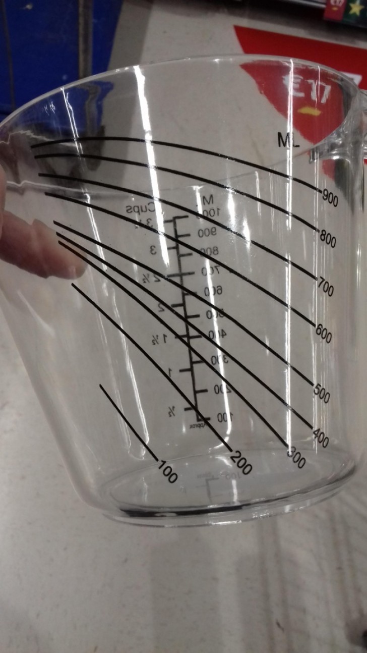 A container with a graduated scale for liquids that is used when it is inclined.