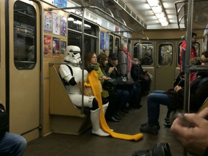 17. A character from Star Wars riding on the subway as it knits a scarf. Everything is within the norm.