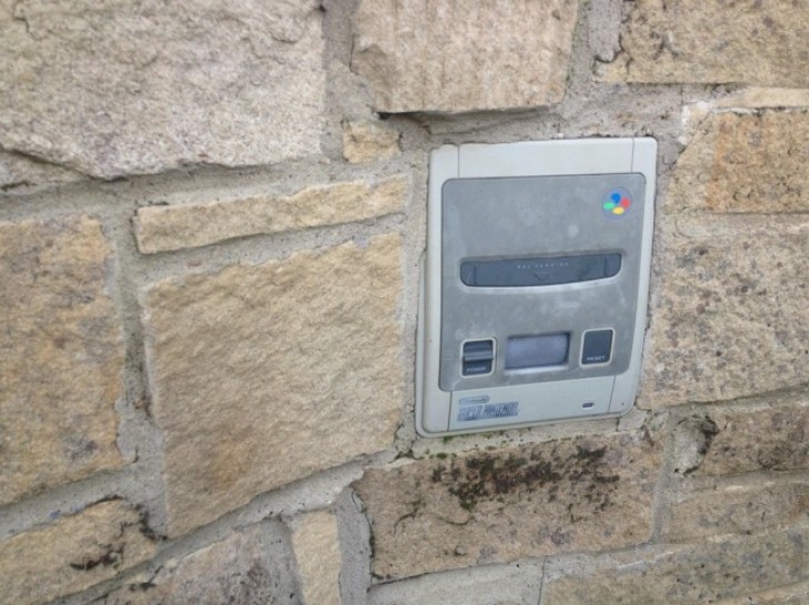 19. A Super Nintendo console inserted into a wall! Is it being used as a mailbox?