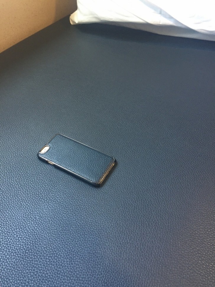The sofa and the leather cover of a smartphone.