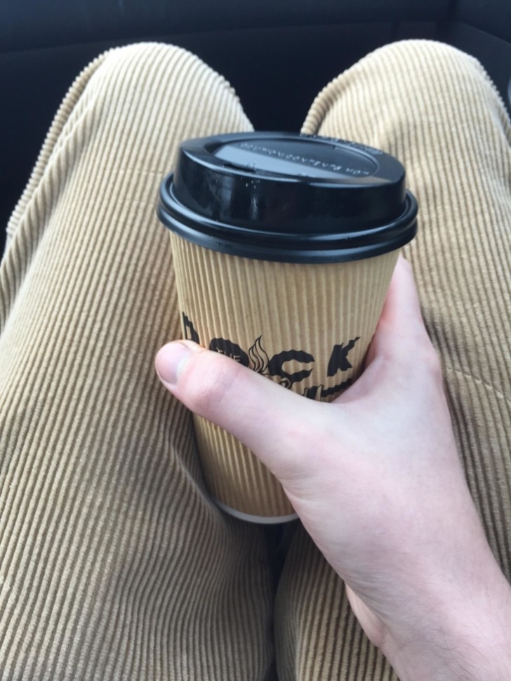 A cup of coffee and corduroy trousers.