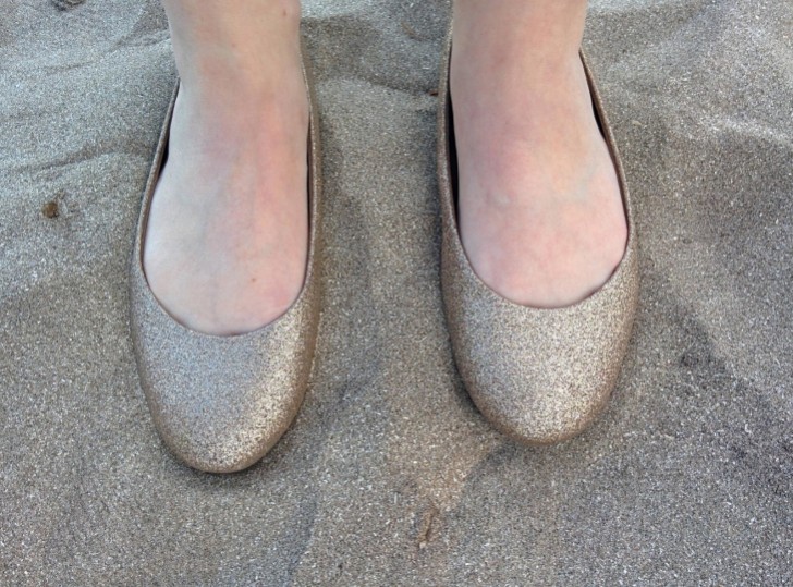 A perfect match these ballerina shoes and the sand.