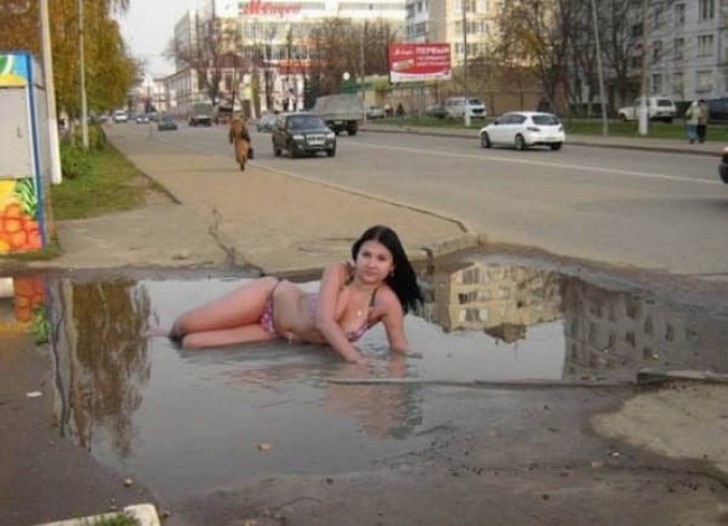 1. A photo shoot in the center of the city ... in a puddle of water.