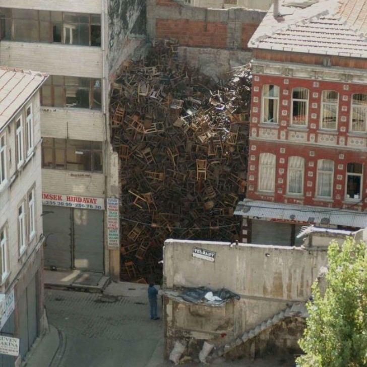 9. Chairs piled high between two buildings (???)