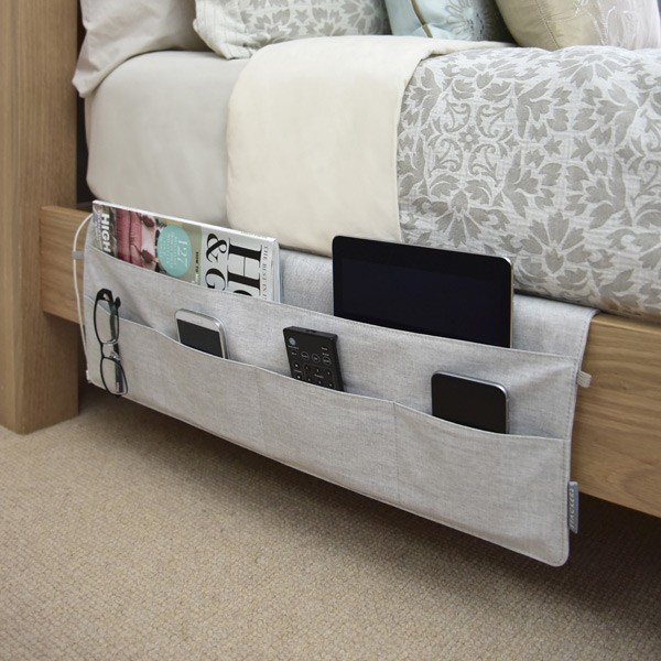 Putting these "pockets" on the bed frame works great and they consume much less space than a bedside table!