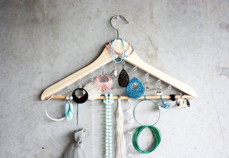 1. Here's how a simple clothes hanger can accommodate earrings and necklaces.