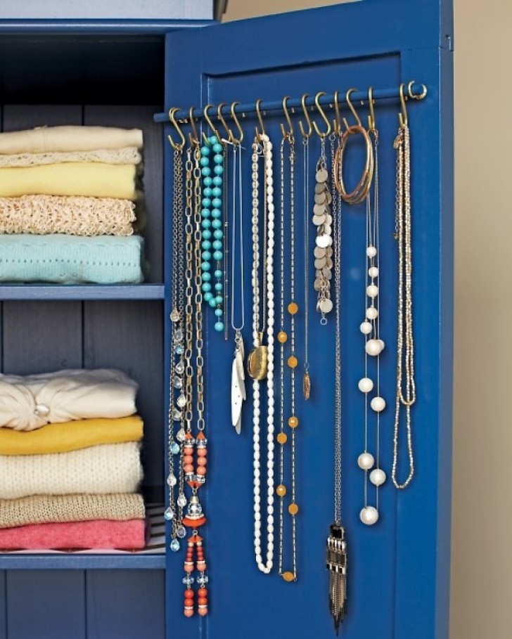22. Take advantage of the interior of doors on furniture to hang and display longer necklaces.