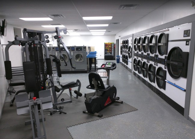 A laundromat with gym equipment.